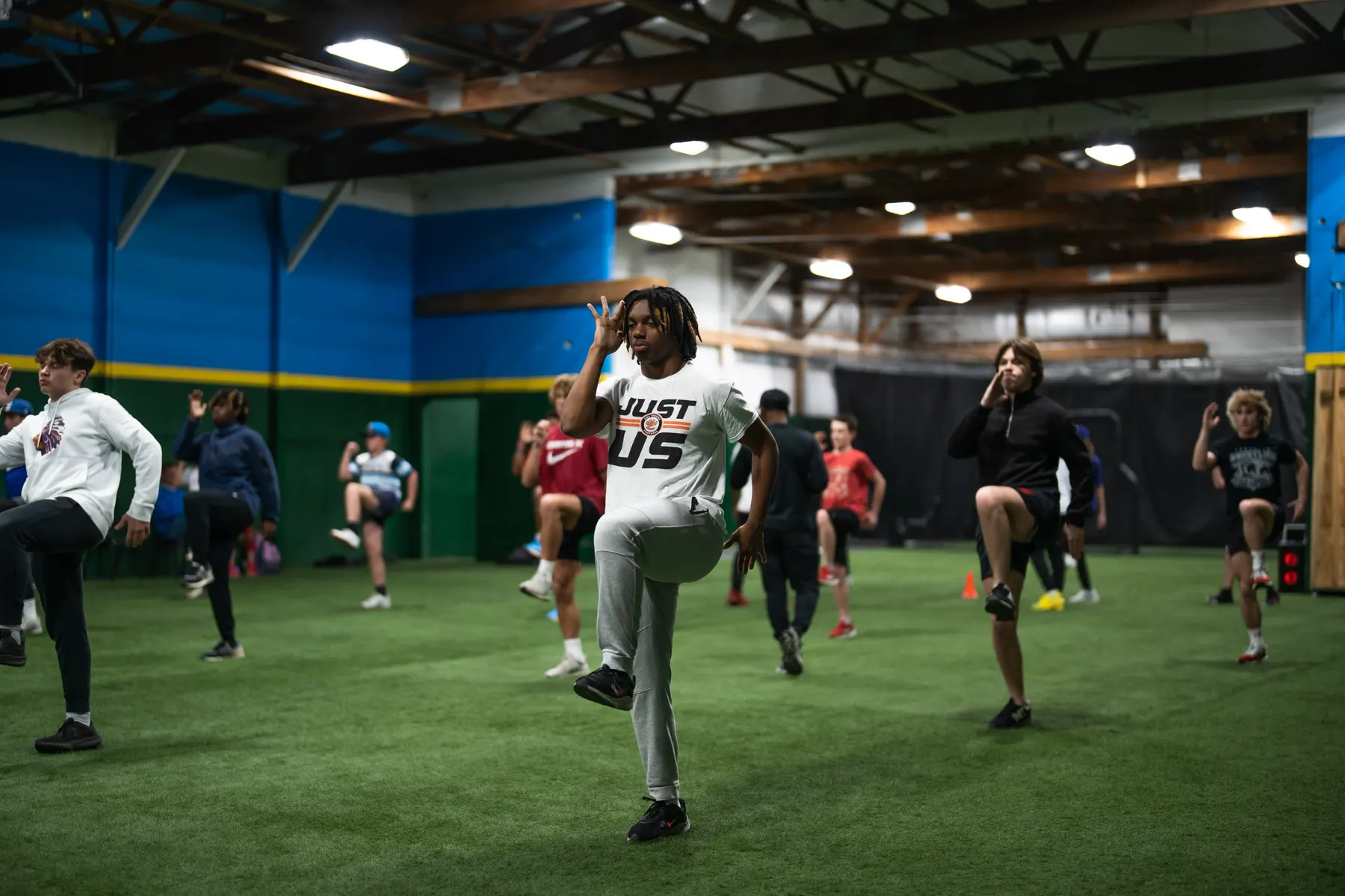 Young athletes running a drill on the indoor turf at Elite Speed in Granite City, Illinois
