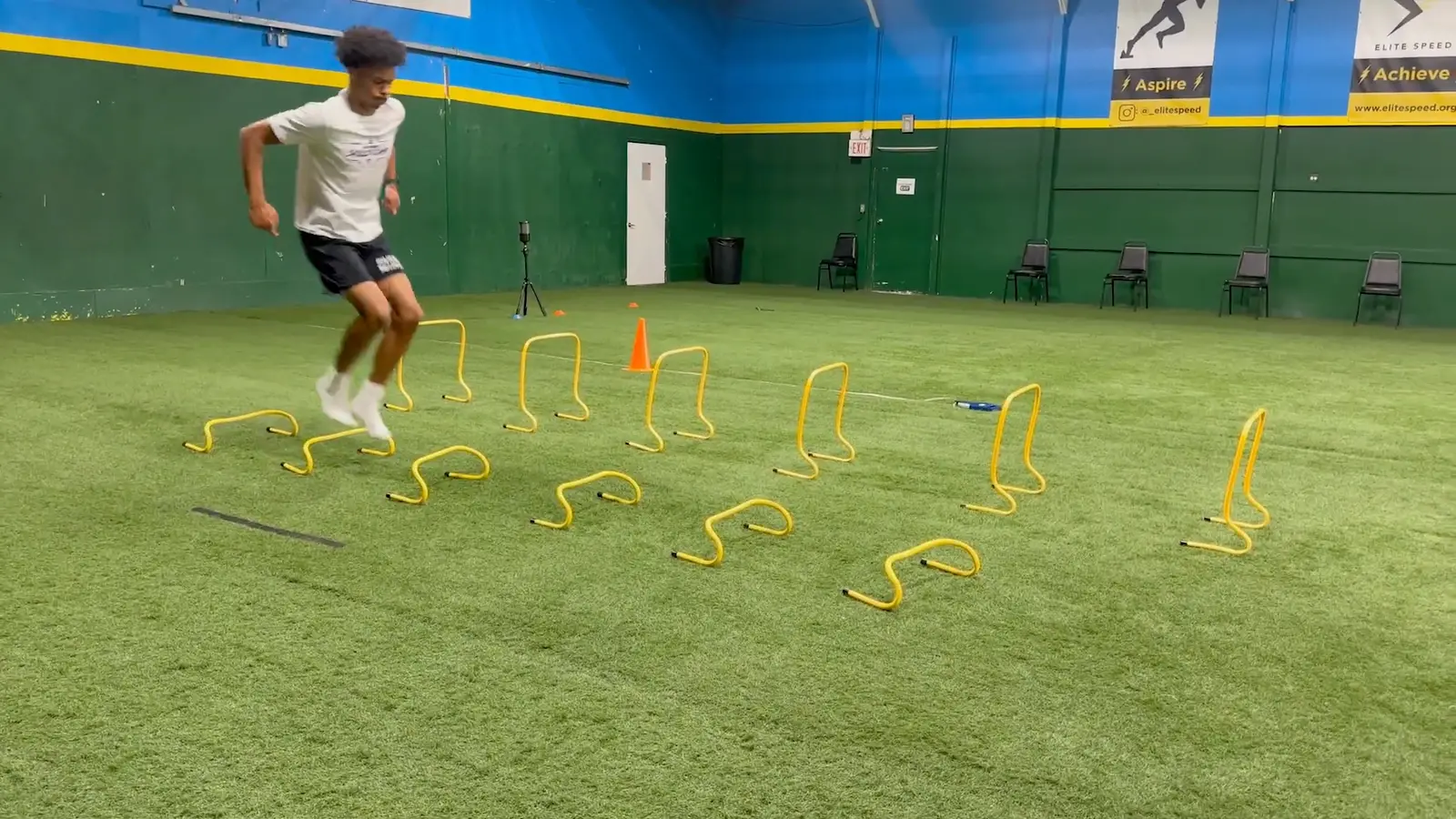 An Elite Speed athlete driving through a grid of mini hurdles on the indoor turf in Granite City, Illinois